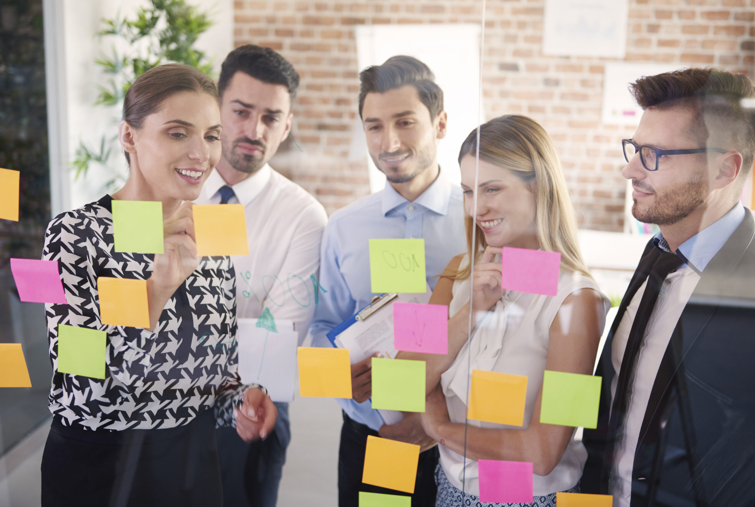 Home team behind glass with colorful papers